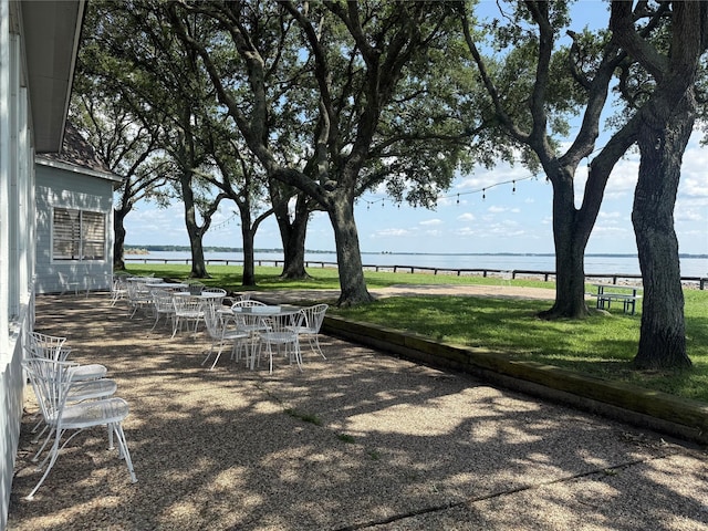 1924 Clipper Ct, Willis, TX 77318 - surrounding community featuring a water view, outdoor dining area, a yard, and a patio area