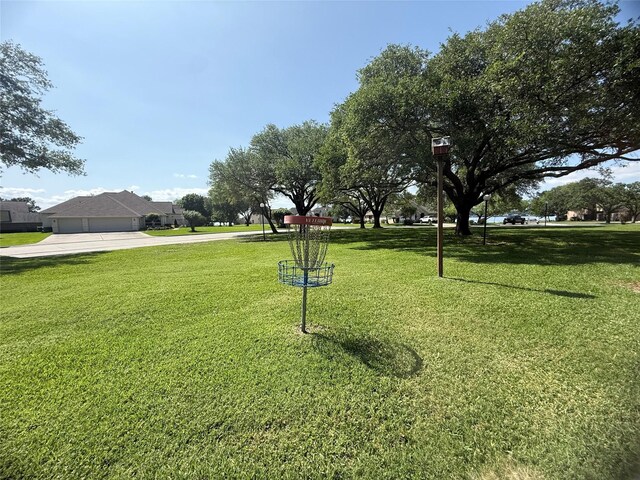 1924 Clipper Ct, Willis, TX 77318 - view of property's community featuring concrete driveway, a yard, and an attached garage