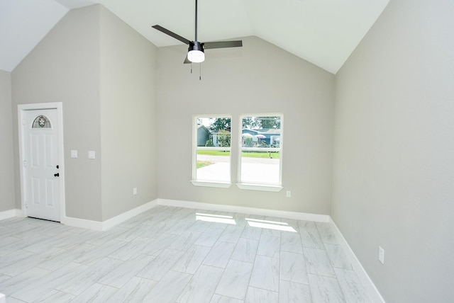 empty room featuring lofted ceiling, a ceiling fan, and baseboards