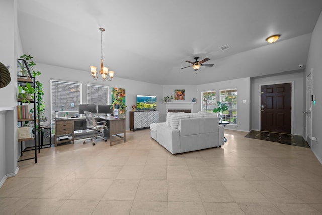 living room with a desk, a ceiling fan, a chandelier, vaulted ceiling, and baseboards