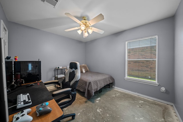 bedroom featuring a desk, concrete flooring, multiple windows, and baseboards