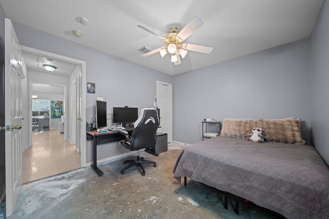 bedroom featuring an office area, concrete floors, and a ceiling fan