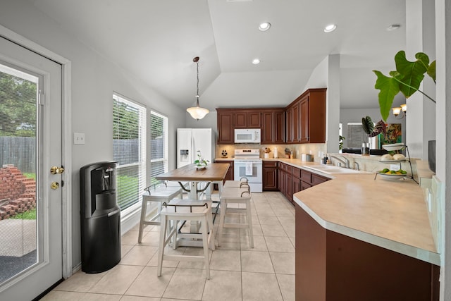 kitchen with white appliances, a sink, light countertops, backsplash, and light tile patterned flooring