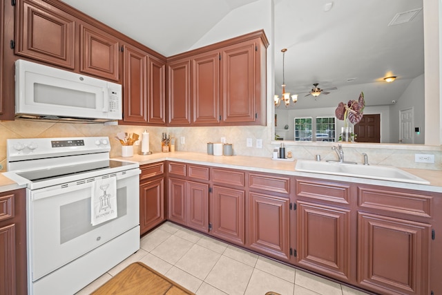 kitchen with white appliances, a sink, vaulted ceiling, light countertops, and tasteful backsplash