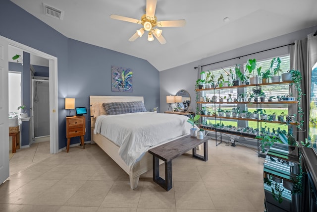 bedroom featuring vaulted ceiling, light tile patterned flooring, and baseboards