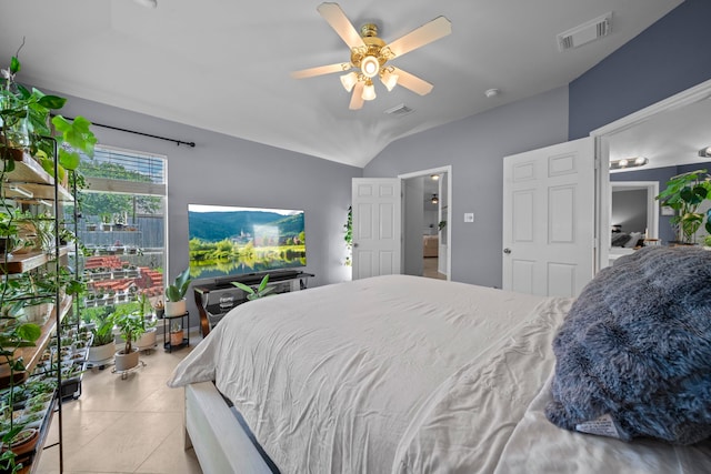 tiled bedroom featuring lofted ceiling and a ceiling fan