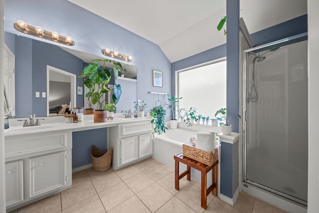 full bathroom featuring tile patterned flooring, a stall shower, double vanity, vaulted ceiling, and a bath