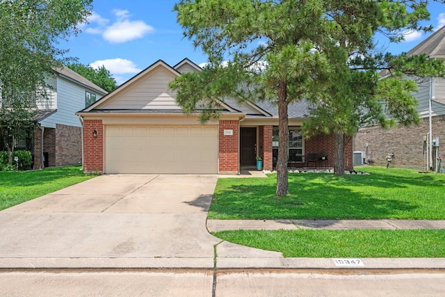 view of front of home featuring an attached garage, brick siding, a front yard, and driveway