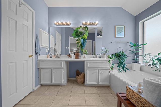 full bathroom featuring tile patterned floors, double vanity, vaulted ceiling, and a bath