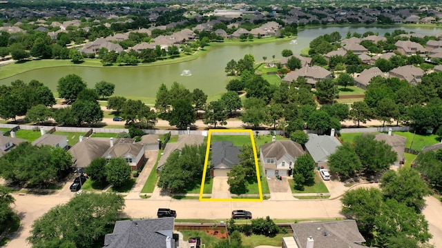 aerial view of residential area with a nearby body of water and property parcel outlined