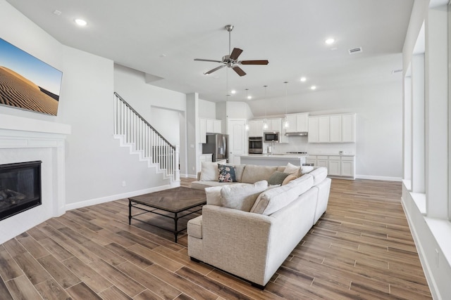 531 Campbell Dr, League City, TX 77573 - living room with ceiling fan, baseboards, light wood-style floors, and recessed lighting