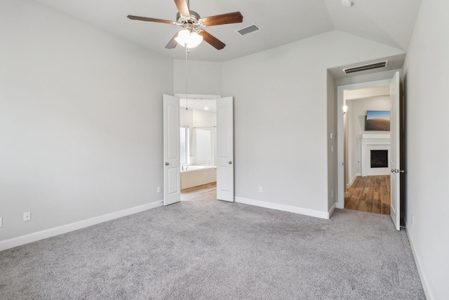 531 Campbell Dr, League City, TX 77573 - unfurnished bedroom featuring light carpet, vaulted ceiling, baseboards, and ensuite bathroom