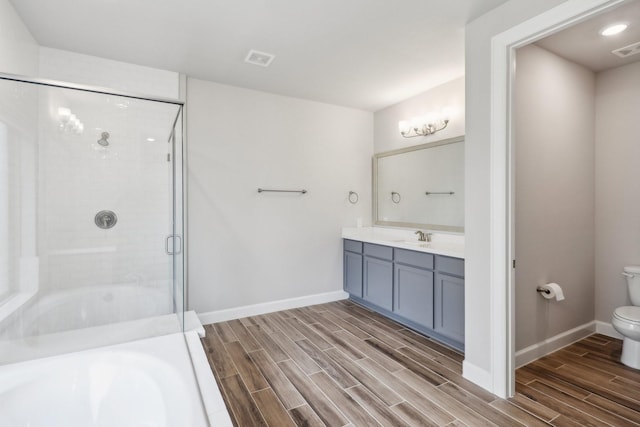 531 Campbell Dr, League City, TX 77573 - full bathroom featuring wood tiled floors, a shower stall, toilet, vanity, and baseboards