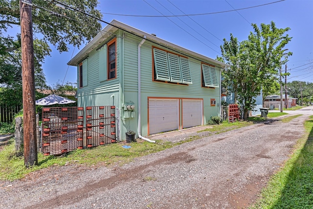 5005 Avenue N Rear Ave N, Rear, Galveston, TX 77551 - view of home's exterior with an attached garage and driveway