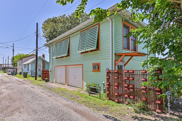 5005 Avenue N Rear Ave N, Rear, Galveston, TX 77551 - view of side of home with a garage