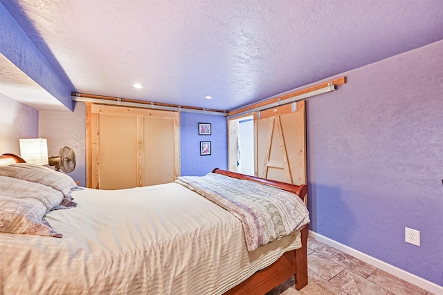 5005 Avenue N Rear Ave N, Rear, Galveston, TX 77551 - bedroom featuring baseboards, a textured ceiling, and recessed lighting