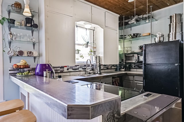 5005 Avenue N Rear Ave N, Rear, Galveston, TX 77551 - kitchen featuring wood ceiling, a sink, freestanding refrigerator, open shelves, and backsplash