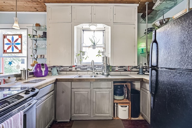 5005 Avenue N Rear Ave N, Rear, Galveston, TX 77551 - kitchen featuring freestanding refrigerator, a sink, white cabinets, and stainless steel range with electric stovetop