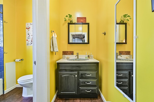 5005 Avenue N Rear Ave N, Rear, Galveston, TX 77551 - bathroom featuring toilet, wood finished floors, vanity, and baseboards