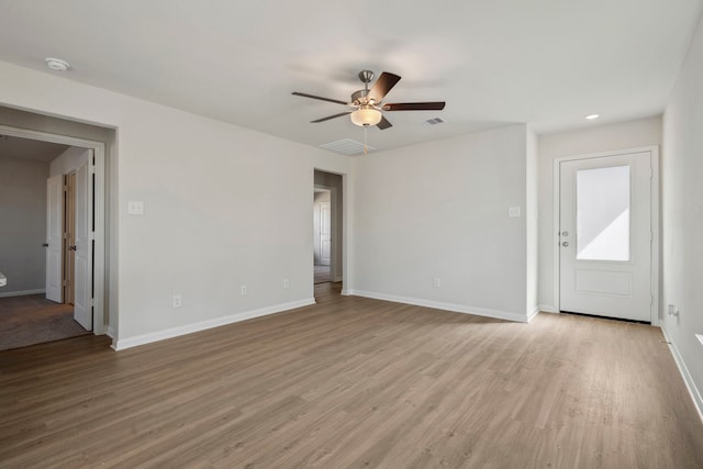 425 Tejas Trl, Waller, TX 77484 - unfurnished living room with ceiling fan, wood finished floors, and baseboards