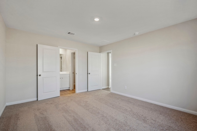425 Tejas Trl, Waller, TX 77484 - unfurnished bedroom with light colored carpet, baseboards, and ensuite bath