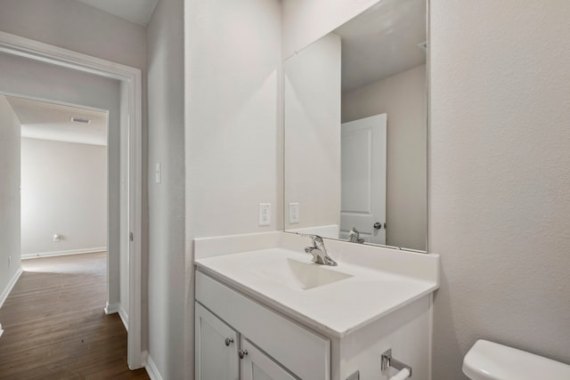 425 Tejas Trl, Waller, TX 77484 - half bathroom featuring toilet, wood finished floors, vanity, and baseboards
