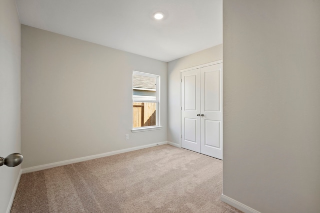 425 Tejas Trl, Waller, TX 77484 - unfurnished bedroom with light colored carpet, baseboards, a closet, and recessed lighting