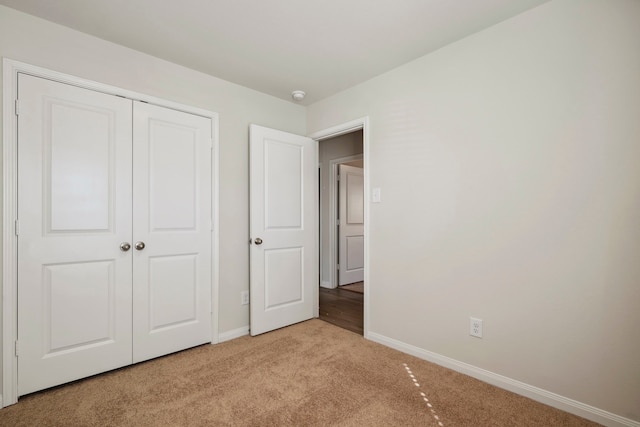 425 Tejas Trl, Waller, TX 77484 - unfurnished bedroom with light colored carpet, baseboards, and a closet