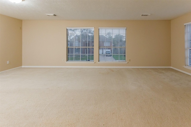 empty room with light colored carpet and baseboards