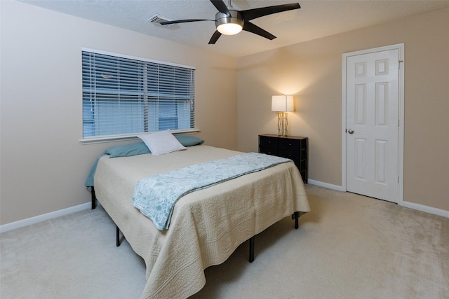bedroom with light colored carpet, baseboards, and ceiling fan