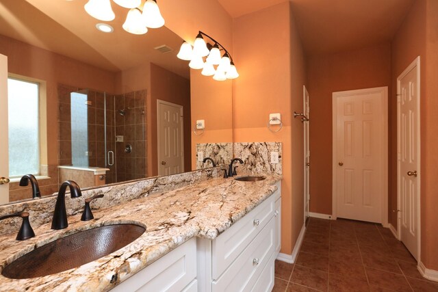 10606 Maidstone Manor Ct, Spring, TX 77379 - full bath with tile patterned floors, a stall shower, a chandelier, double vanity, and baseboards