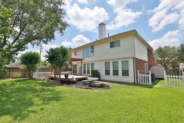 10606 Maidstone Manor Ct, Spring, TX 77379 - back of house featuring a chimney, a deck, brick siding, and central AC