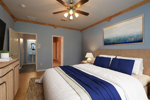 10606 Maidstone Manor Ct, Spring, TX 77379 - bedroom with crown molding, wood finished floors, a ceiling fan, and connected bathroom