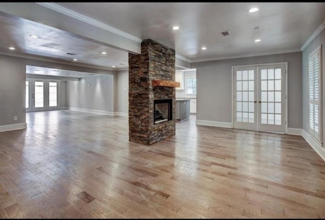 808 Chimney Rock Rd, Houston, TX 77056 - unfurnished living room featuring crown molding, french doors, light wood finished floors, baseboards, and recessed lighting