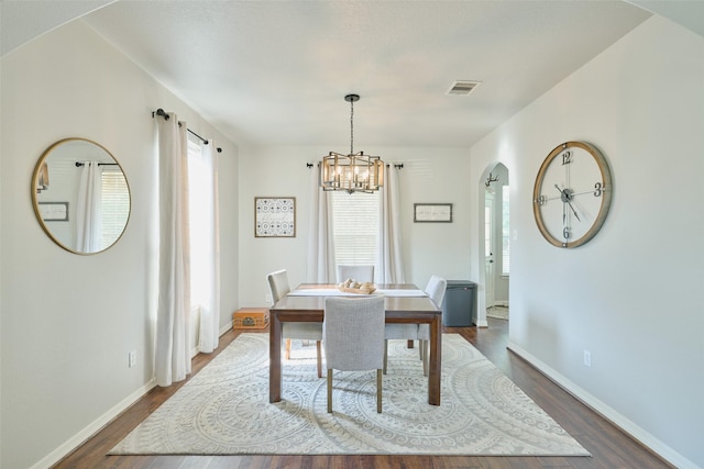 7503 Revelwood Dr, Magnolia, TX 77354 - dining room with healthy amount of natural light, a chandelier, and dark wood finished floors