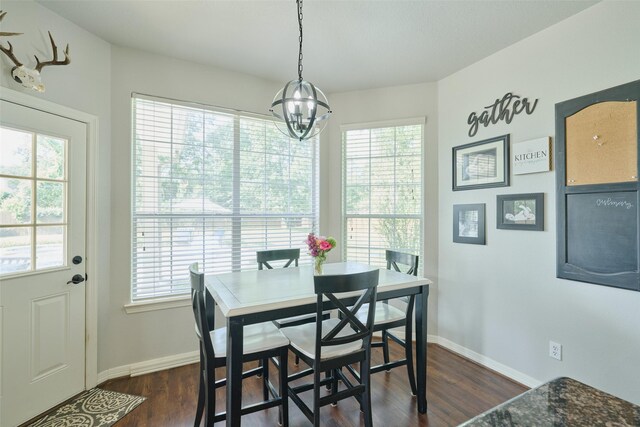 7503 Revelwood Dr, Magnolia, TX 77354 - dining area featuring baseboards, dark wood-style flooring, and a chandelier