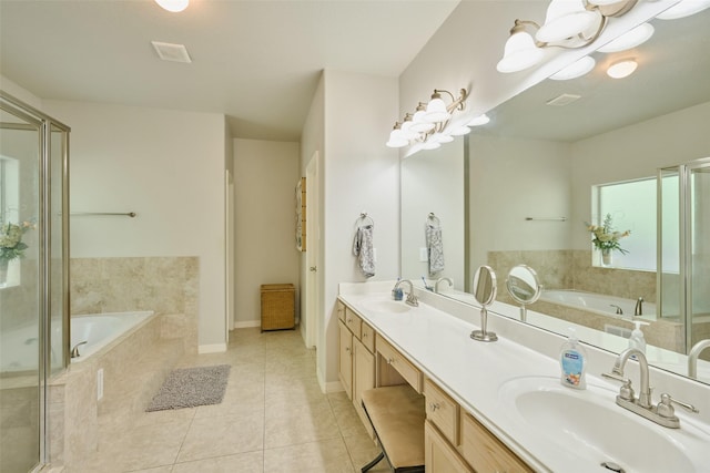 7503 Revelwood Dr, Magnolia, TX 77354 - bathroom featuring tile patterned floors, double vanity, a garden tub, a stall shower, and baseboards