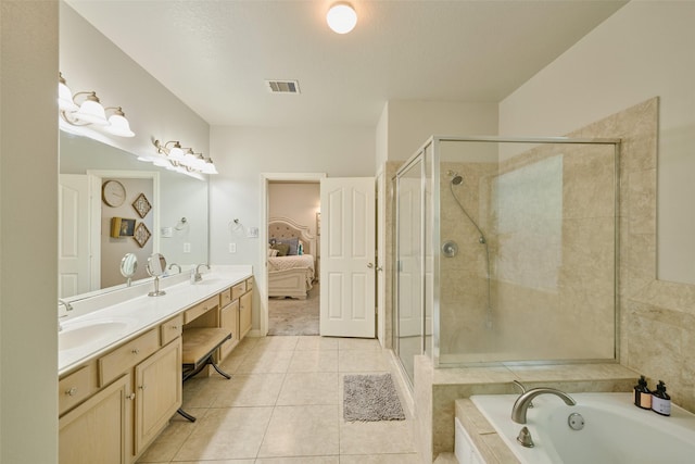 7503 Revelwood Dr, Magnolia, TX 77354 - ensuite bathroom featuring double vanity, a garden tub, a shower stall, and tile patterned floors