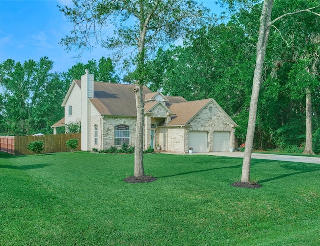 7503 Revelwood Dr, Magnolia, TX 77354 - view of front of property with concrete driveway, stone siding, an attached garage, and a chimney