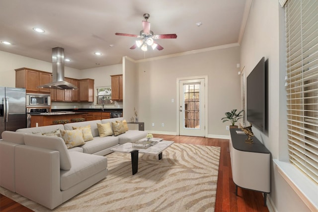 living room with ceiling fan, light wood-style flooring, crown molding, recessed lighting, and baseboards