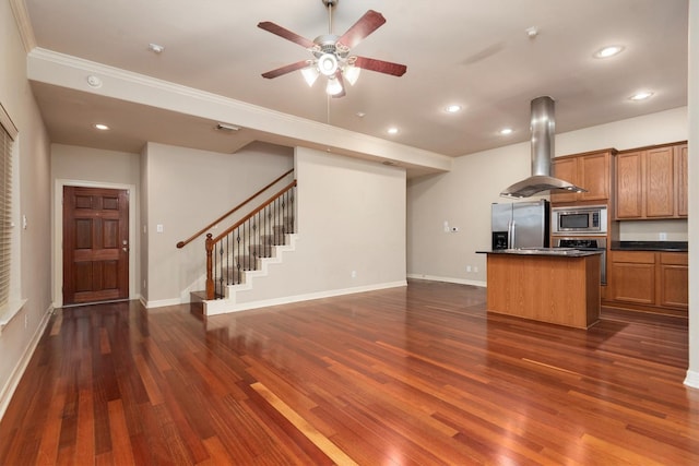 kitchen with stainless steel appliances, island range hood, dark countertops, dark wood-style flooring, and open floor plan