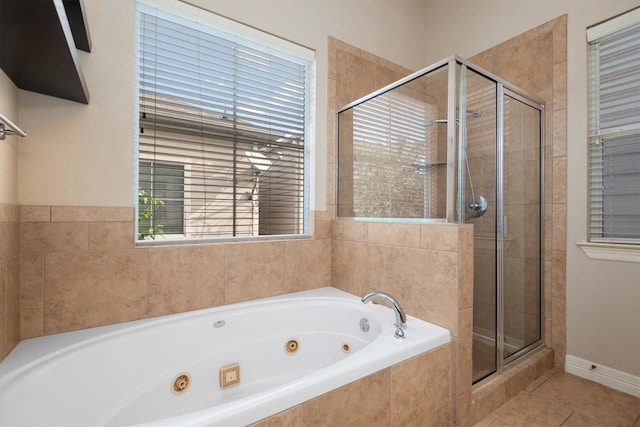 full bathroom featuring a shower stall, a tub with jets, tile patterned floors, and healthy amount of natural light