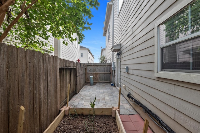 view of side of home with a patio and a fenced backyard