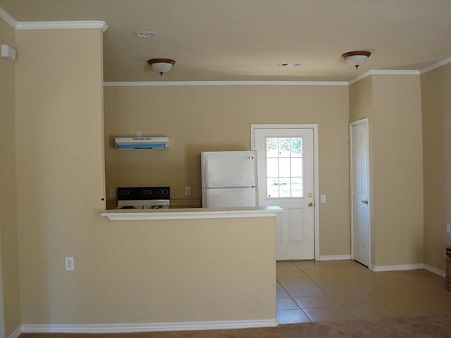 104 Longstreet Rd, Willis, TX 77378 - kitchen featuring freestanding refrigerator, range, ornamental molding, a peninsula, and light tile patterned floors