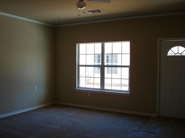 104 Longstreet Rd, Willis, TX 77378 - entrance foyer with dark carpet, healthy amount of natural light, ceiling fan, baseboards, and ornamental molding