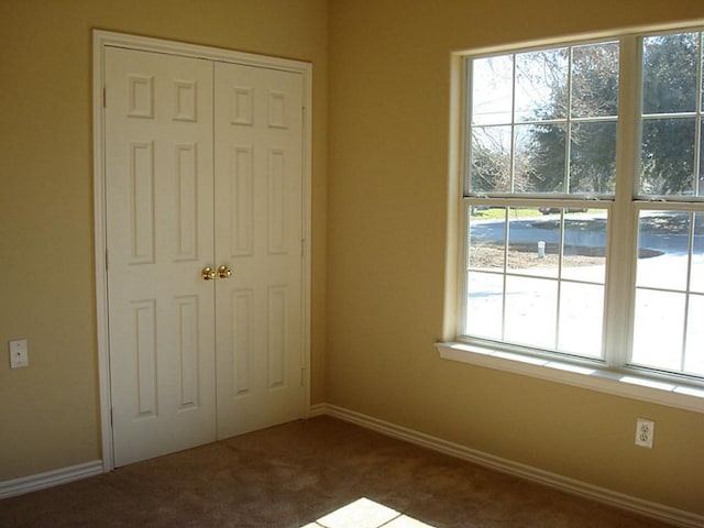 104 Longstreet Rd, Willis, TX 77378 - unfurnished bedroom with carpet flooring, a closet, and baseboards