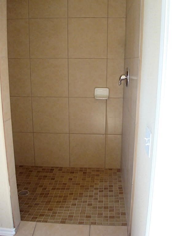 104 Longstreet Rd, Willis, TX 77378 - full bathroom featuring a shower stall and tile patterned floors