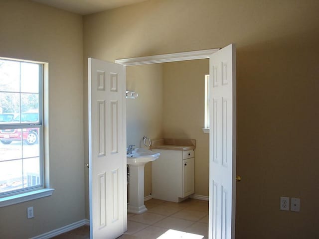 104 Longstreet Rd, Willis, TX 77378 - washroom with healthy amount of natural light, light tile patterned flooring, and baseboards