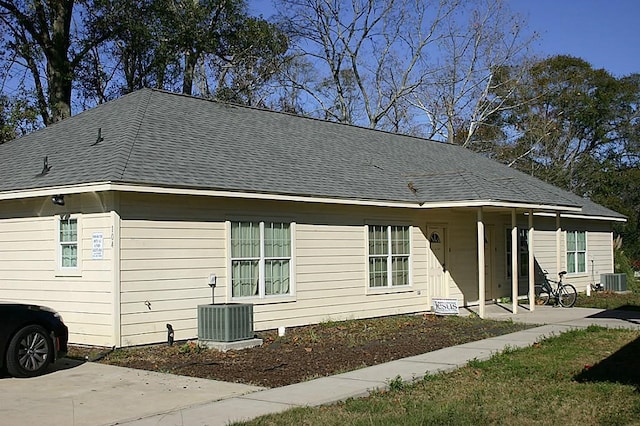 104 Longstreet Rd, Willis, TX 77378 - back of property with central AC and a shingled roof