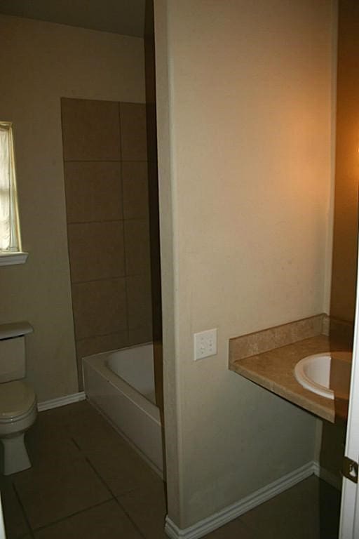 104 Longstreet Rd, Willis, TX 77378 - bathroom with tile patterned flooring, toilet, and baseboards